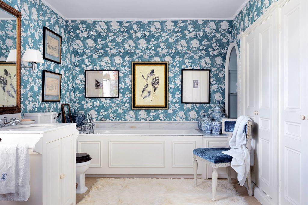 The blue and white floral wallpaper in this bathroom Penny Morrison's 'Flowerberry' the palette of which is reflected in...