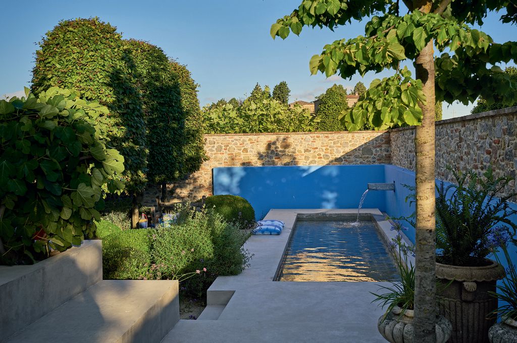 Image may contain Flagstone Outdoors Garden Plant Tree Water Arbour Hotel and Building