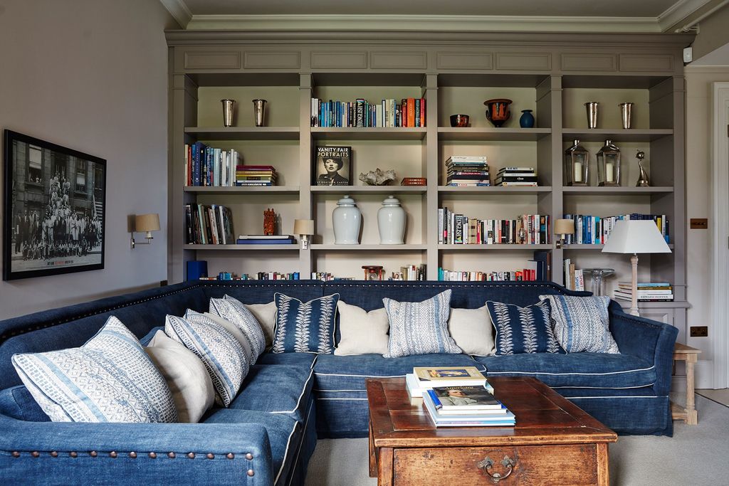 Image may contain Furniture Couch Living Room Room Indoors Bookcase Cushion Table and Shelf