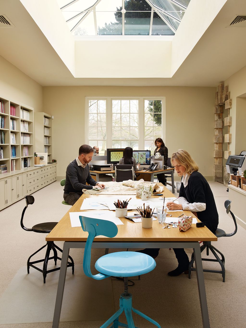 Image may contain Human Person Furniture Chair Wood Restaurant Indoors Plywood Cafeteria and Table