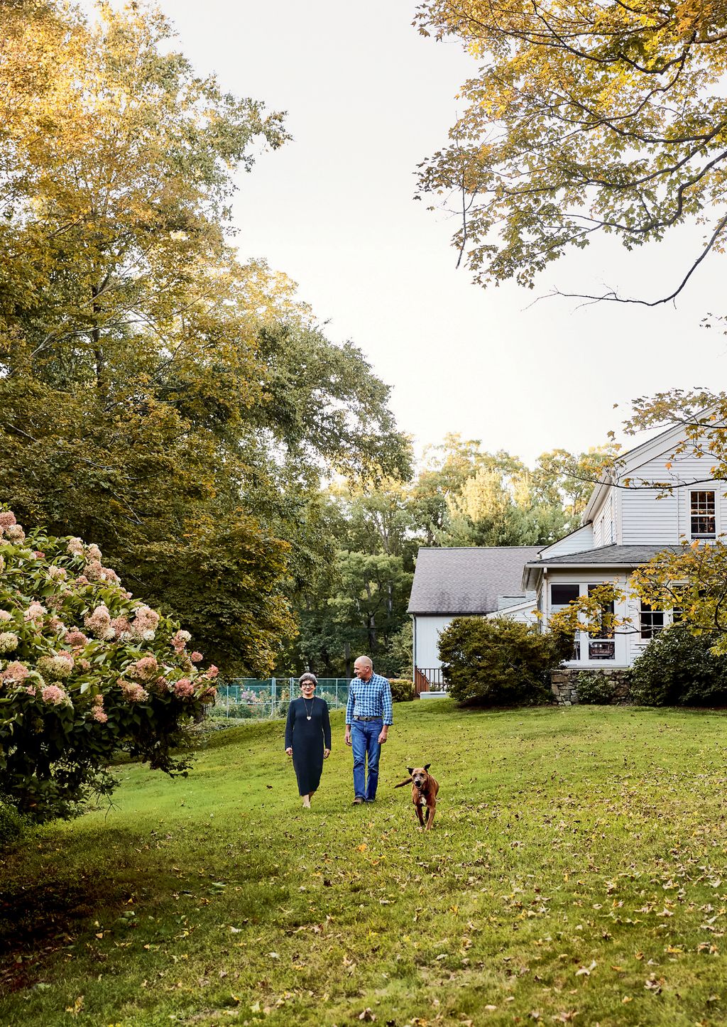 Frances Wally and their dog Peter in the garden.