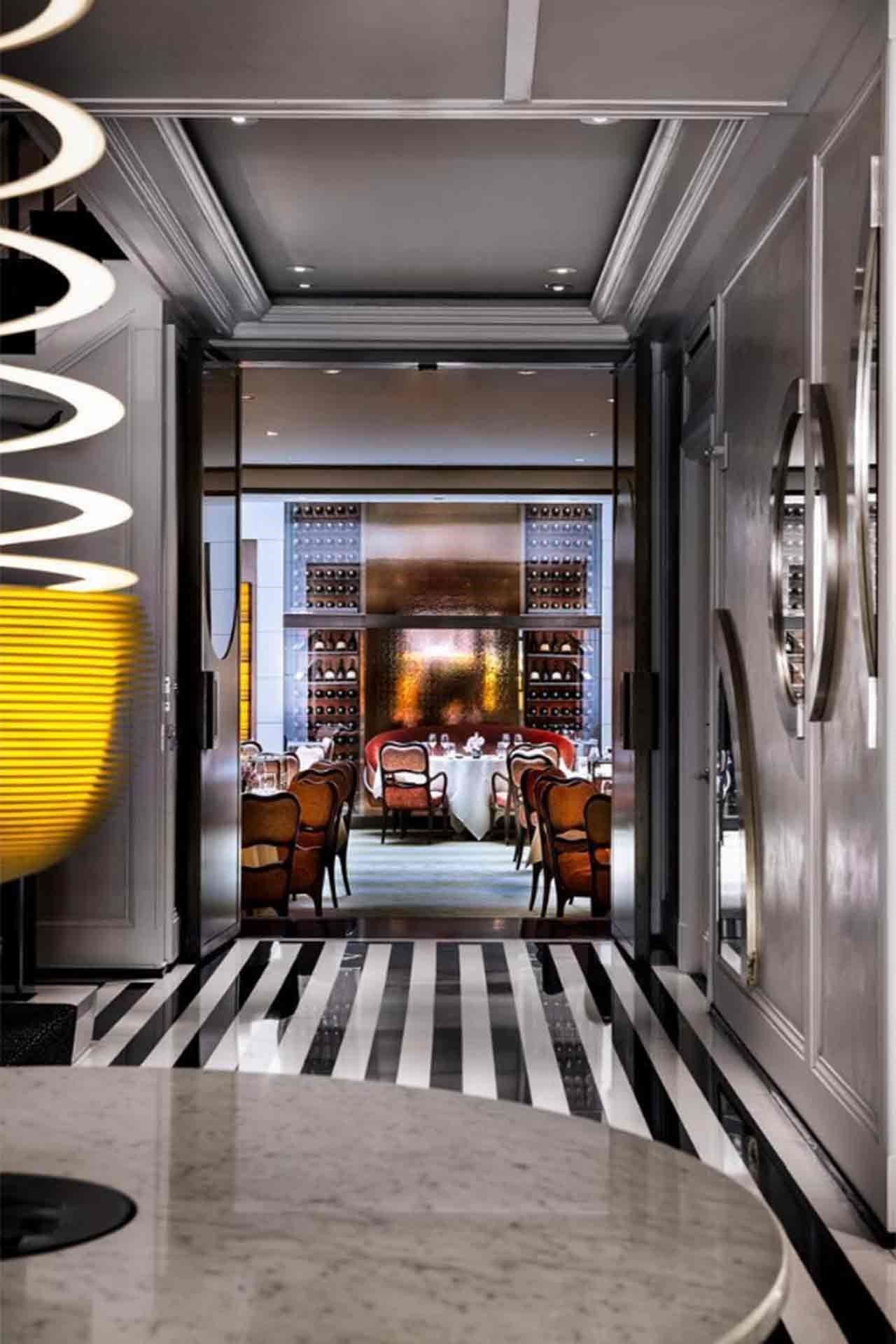 Image may contain Furniture Chair Interior Design Indoors Floor Flooring Lighting Restaurant Corridor and Cafe