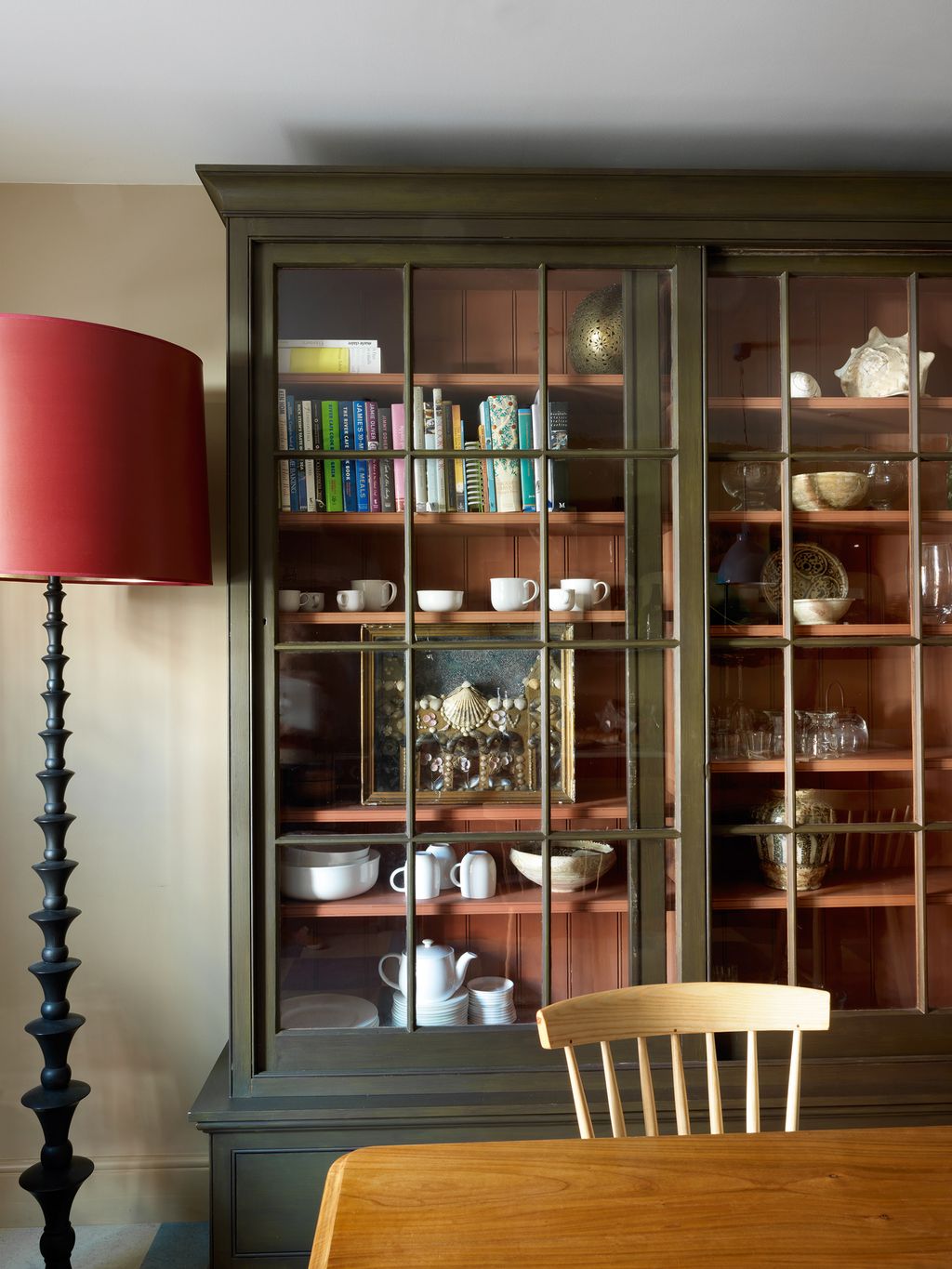 Image may contain Furniture Chair Shelf Cabinet China Cabinet Lamp and Table Lamp