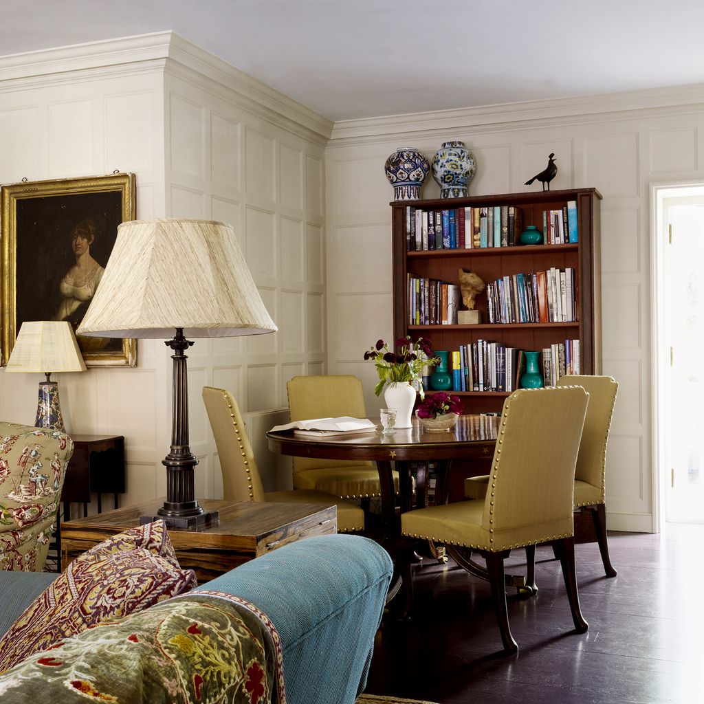 Image may contain Furniture Living Room Room Indoors Couch Chair Bookcase Shelf Interior Design Flooring and Human