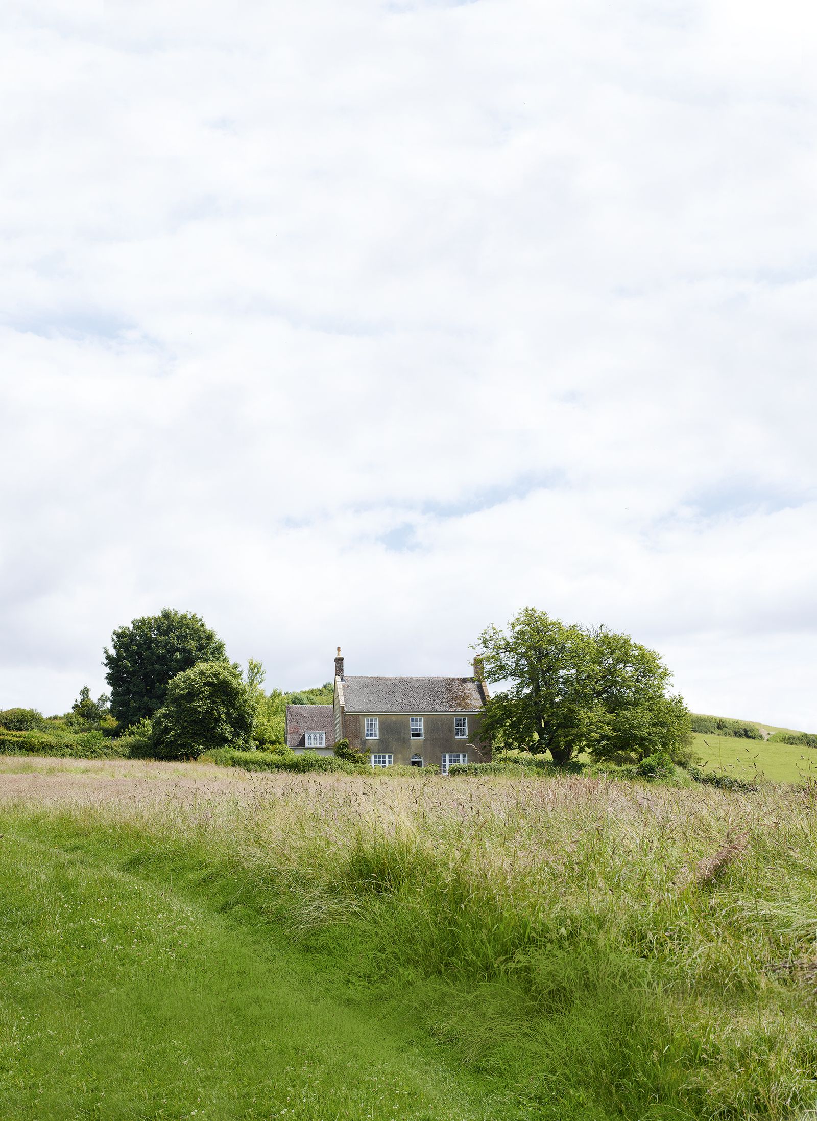 Image may contain Grassland Outdoors Field Nature Countryside Building Rural Grass Plant Farm Meadow and Housing