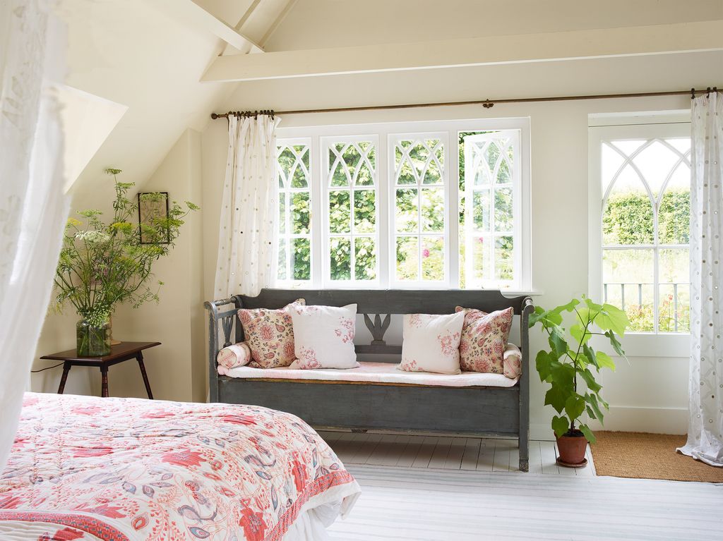 Eyecatching textiles provide visual interest in this light and airy bedroom. The quilt is from Oka and the mirrored...