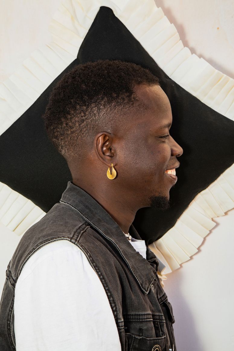 Image may contain: Hair, Cushion, Human, Person, Clothing, Apparel, Face, and Head