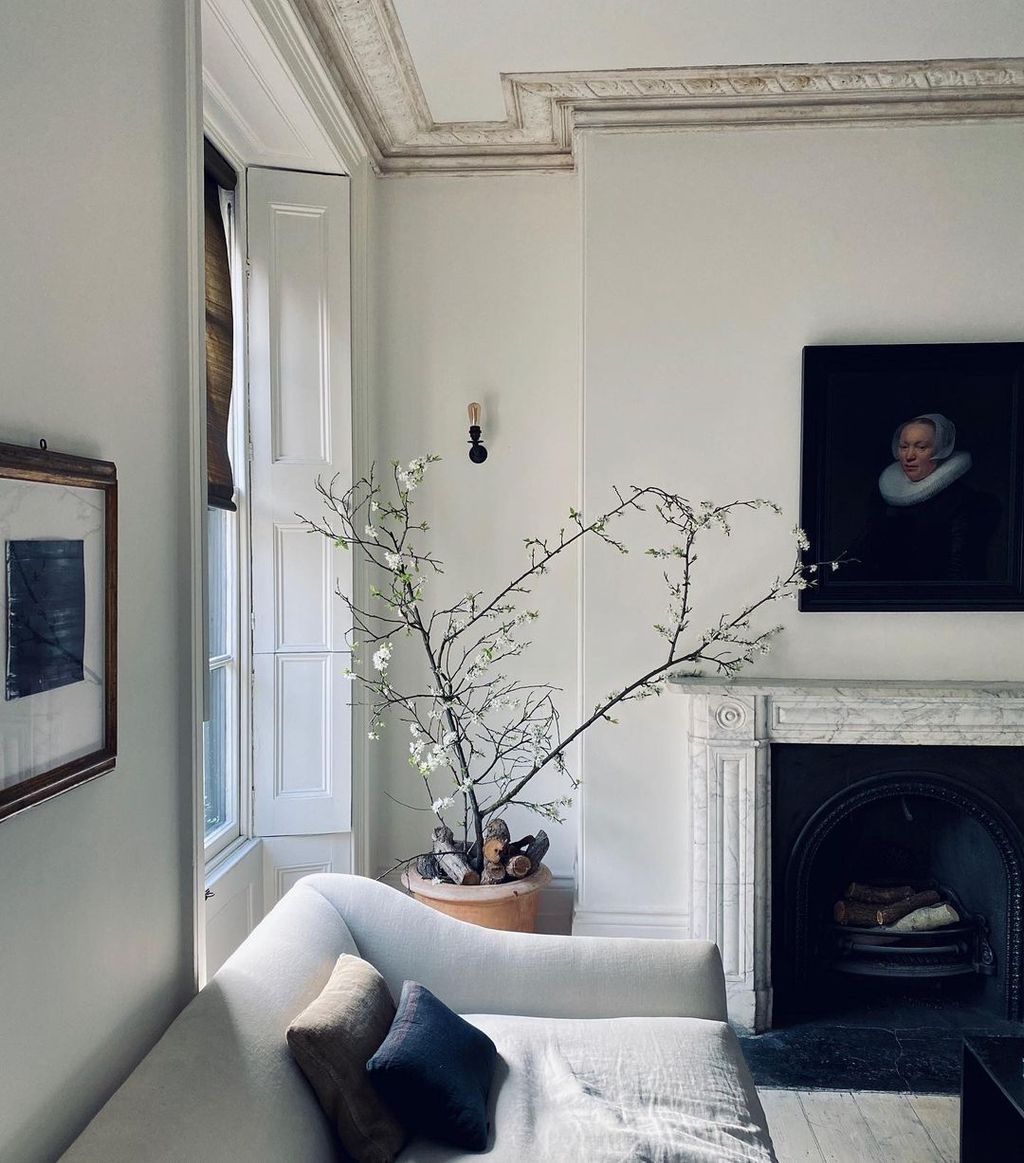 Image may contain Interior Design Indoors Flower Ornament Vase Human Plant Art Pottery and Ikebana