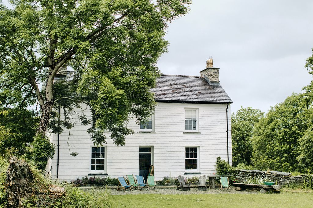 Image may contain Grass Plant Housing Building Tree Cottage House Lawn and Outdoors