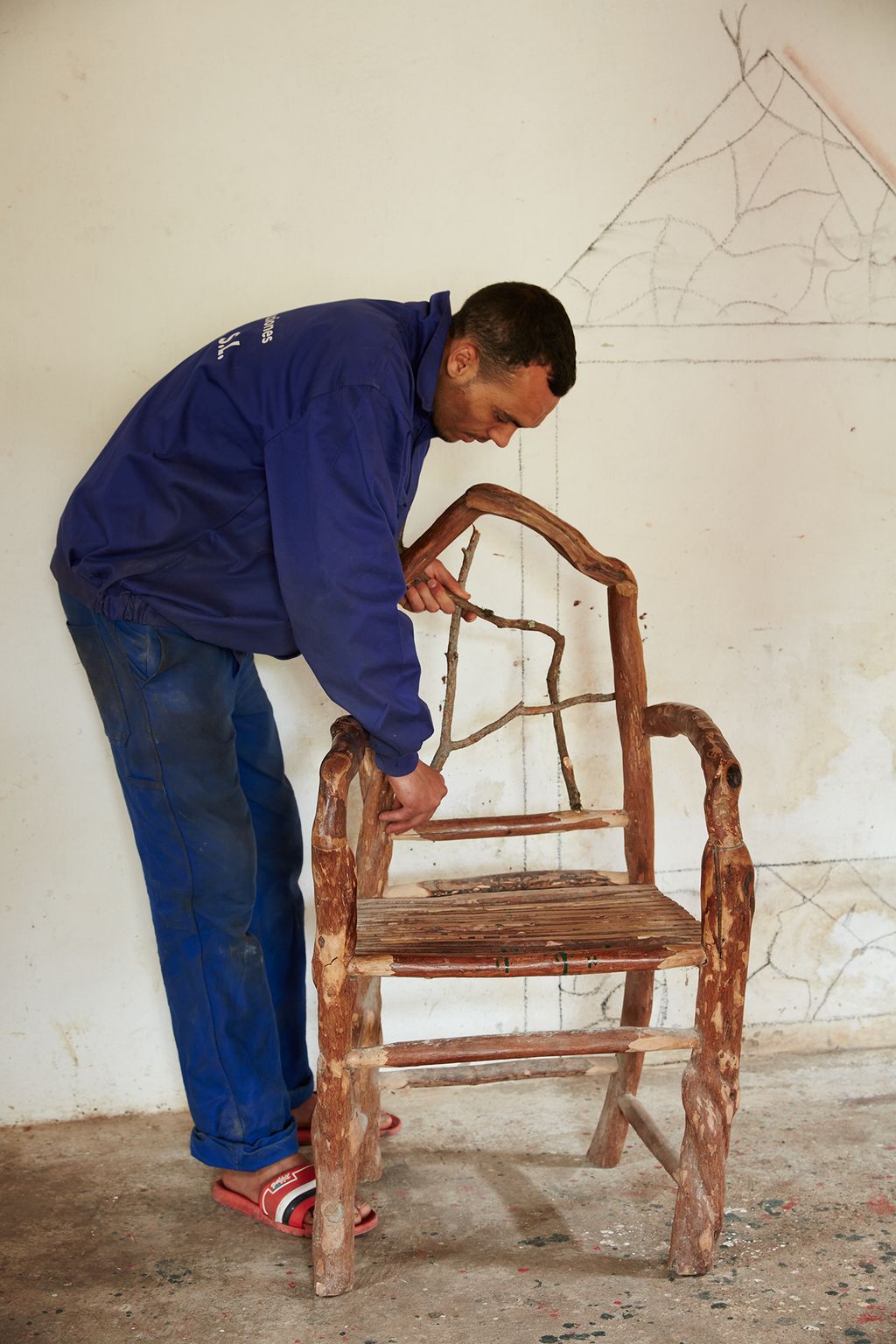 Image may contain Human Person Furniture Pants Clothing Apparel Wood Footwear Shoe Denim and Jeans