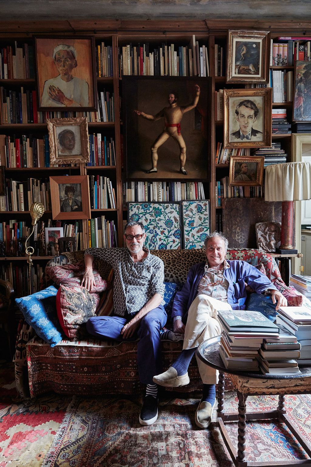 Image may contain Furniture Shelf Couch Footwear Clothing Shoe Apparel Bookcase Human Person Living Room and Room