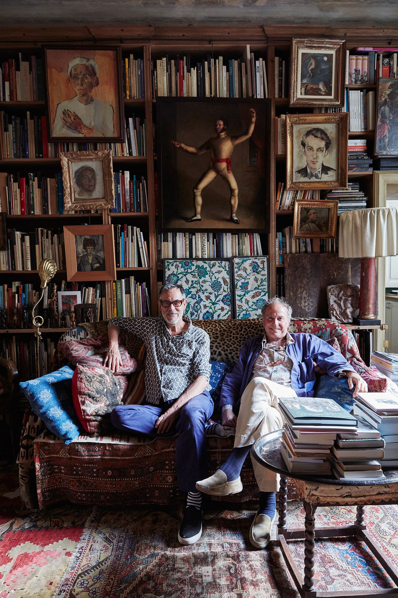 Image may contain Furniture Shelf Couch Footwear Clothing Shoe Apparel Bookcase Human Person Living Room and Room