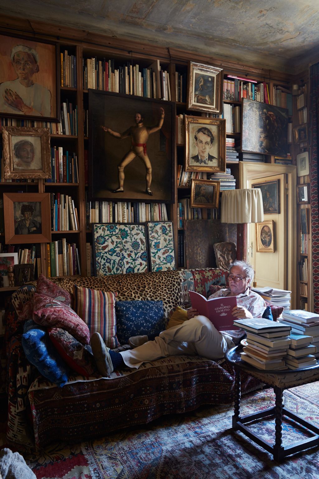 Image may contain Furniture Living Room Room Indoors Bookcase Couch Shelf Interior Design Human Person and Book