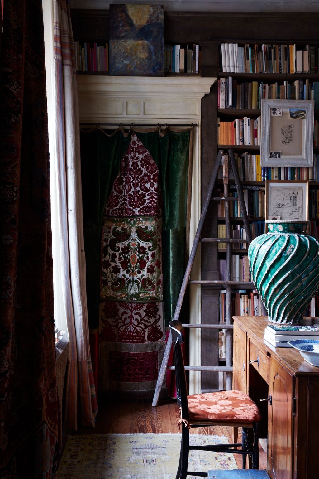 Image may contain Furniture Chair Shelf Bookcase Interior Design Indoors Home Decor Room Wood and Living Room