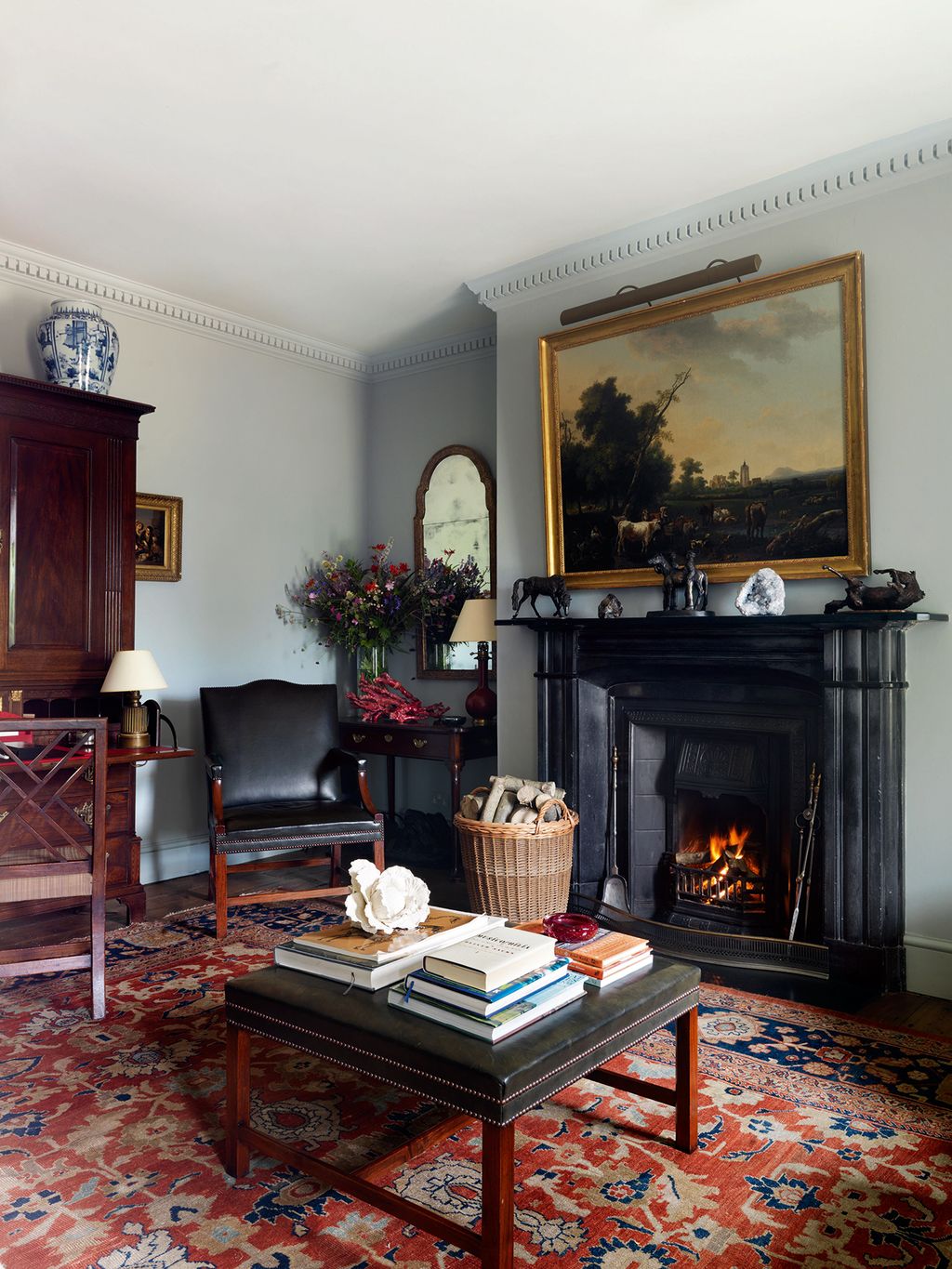 Image may contain Living Room Room Indoors Fireplace Furniture Hearth Interior Design and Rug