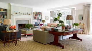 Image may contain Furniture Living Room Room Indoors Table Coffee Table Couch Flooring and Interior Design