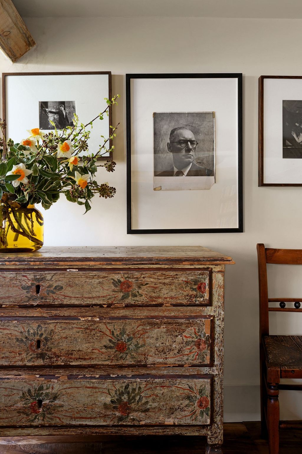 On the balcony landing black and white photographs by Roger Mayne John Deakin and Peter Rose Pulham hang above a...