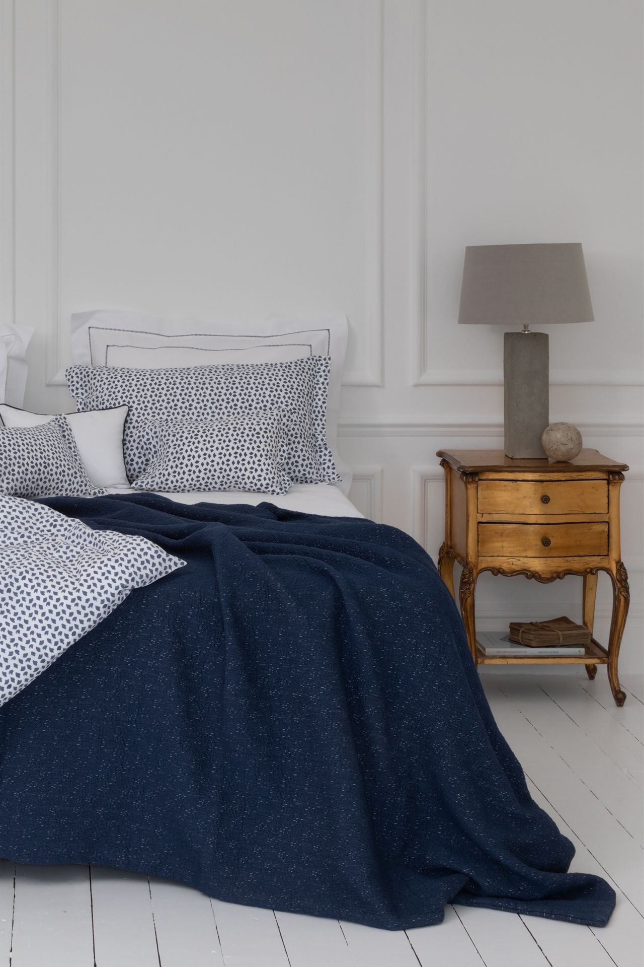 Image may contain Indoors Room Bedroom Furniture Bed Dorm Room Lamp and Table Lamp