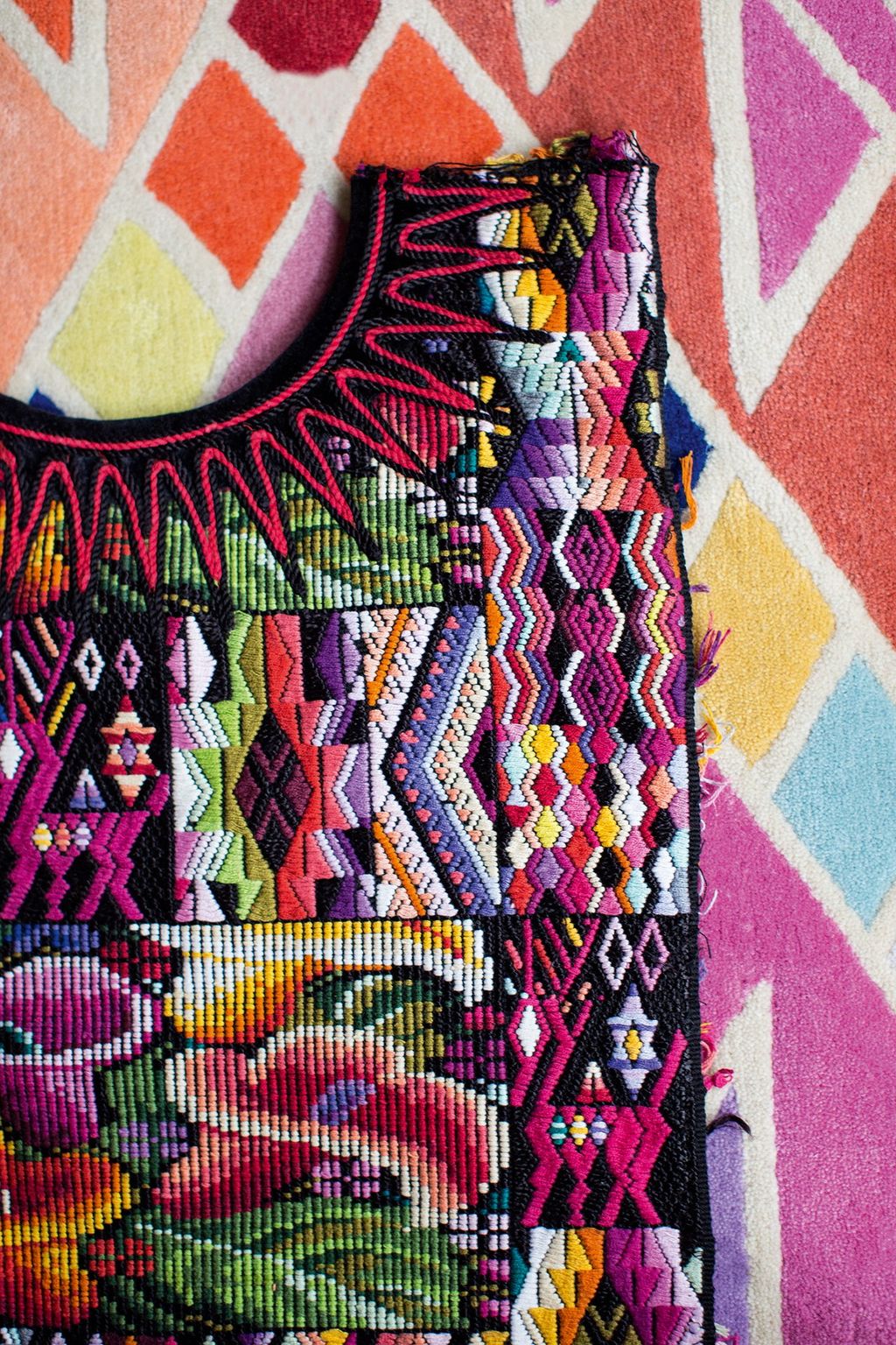 A vintage huipil lying on the 'Wawa' wool rug.