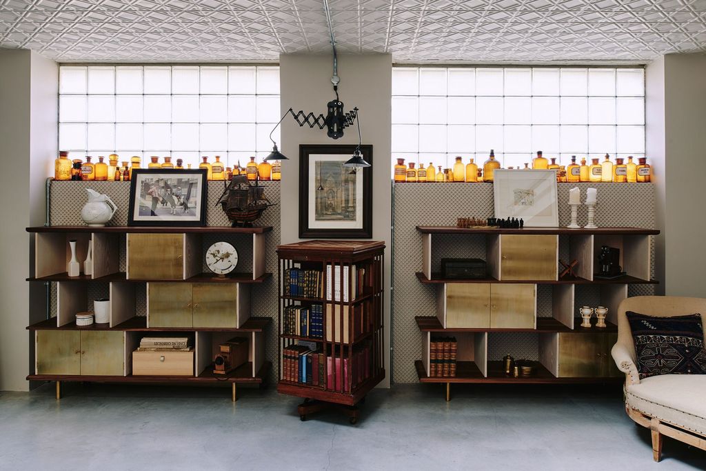 Image may contain Furniture Shelf Bookcase Human Person Interior Design Indoors Clock Tower Architecture and Tower