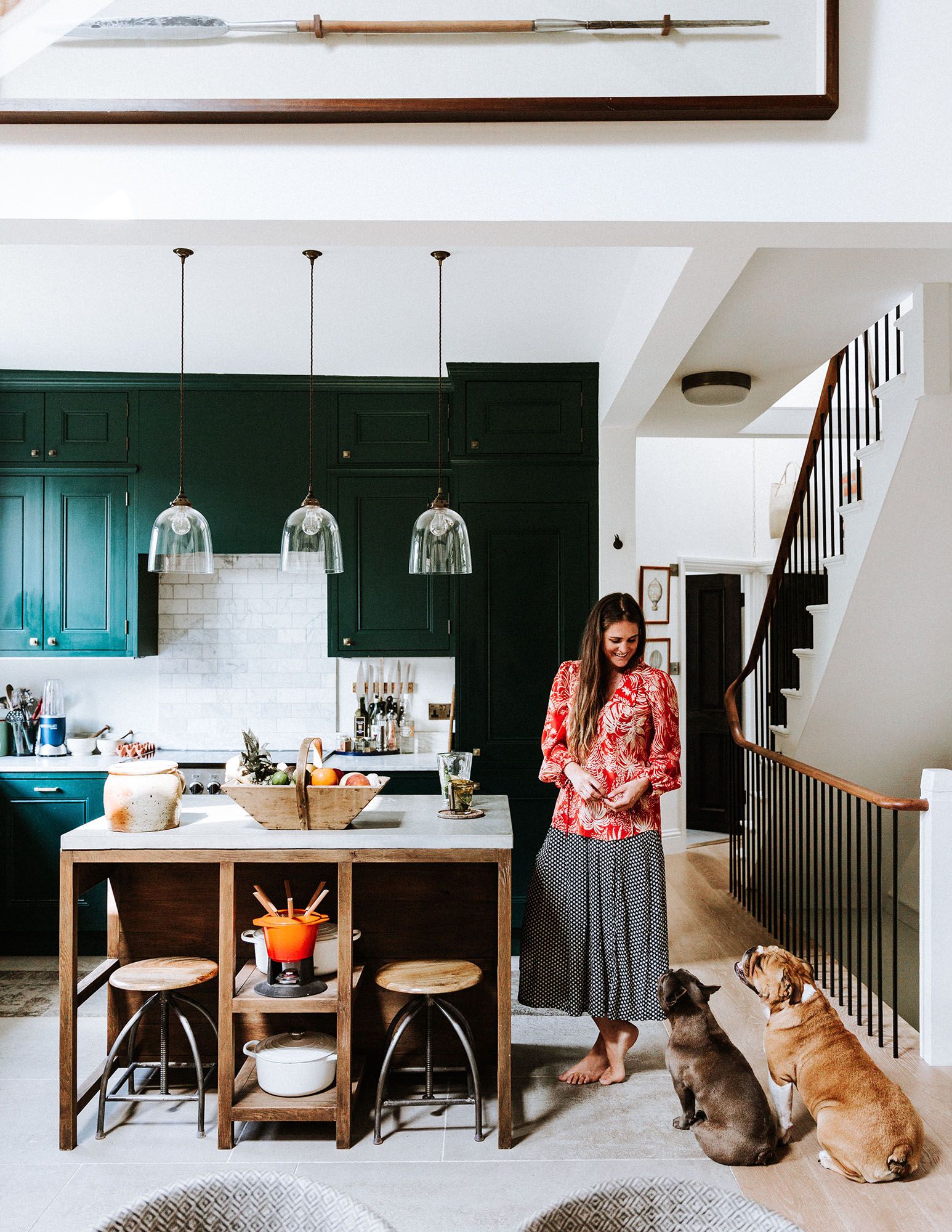 Image may contain Furniture Human Person Indoors Room Living Room Bar Stool Dining Table Table and Interior Design