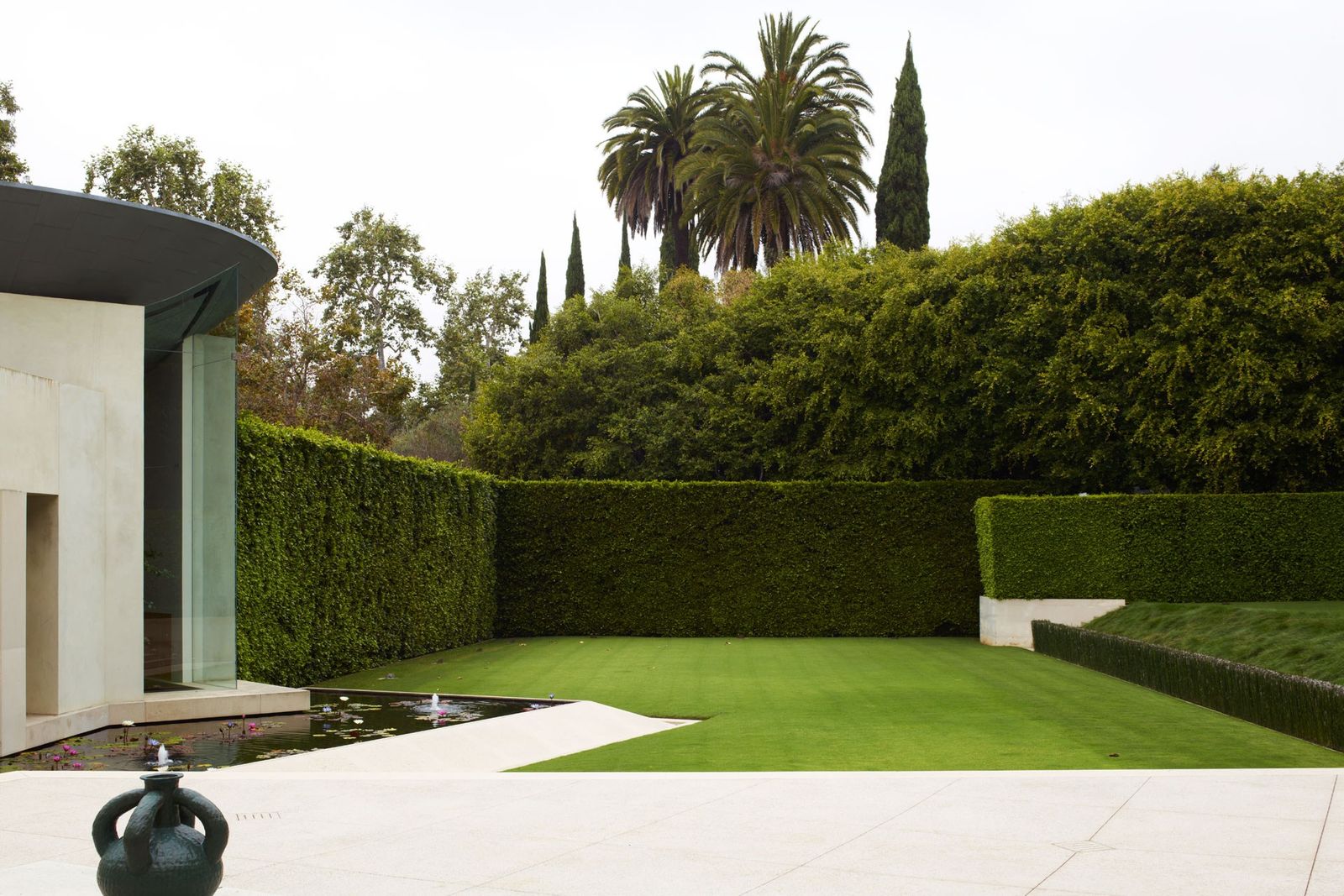 Image may contain Grass Plant Outdoors Vegetation Hedge Fence Garden and Arbour