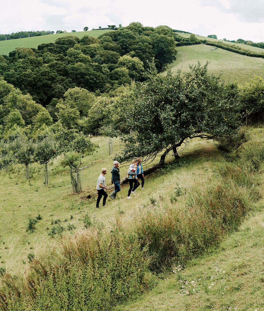 Image may contain Human Person Outdoors Nature Field Grassland Countryside Rural Farm Tree and Plant