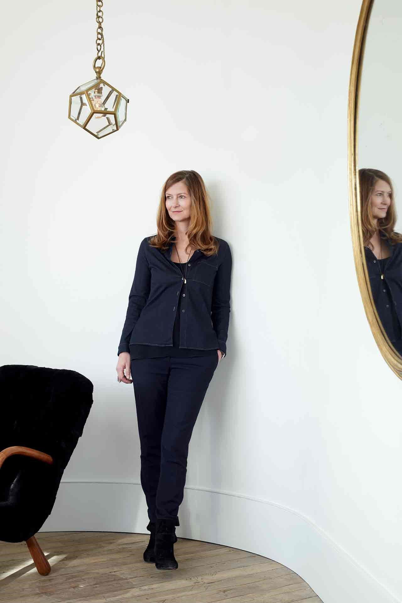 Image may contain Clothing Apparel Human Person Suit Coat Overcoat Dress Blonde Teen Kid and Child