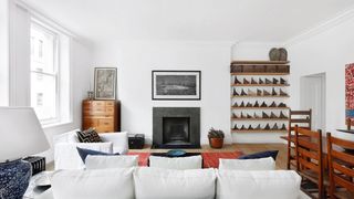 Image may contain Living Room Room Indoors Interior Design Furniture Couch and Fireplace