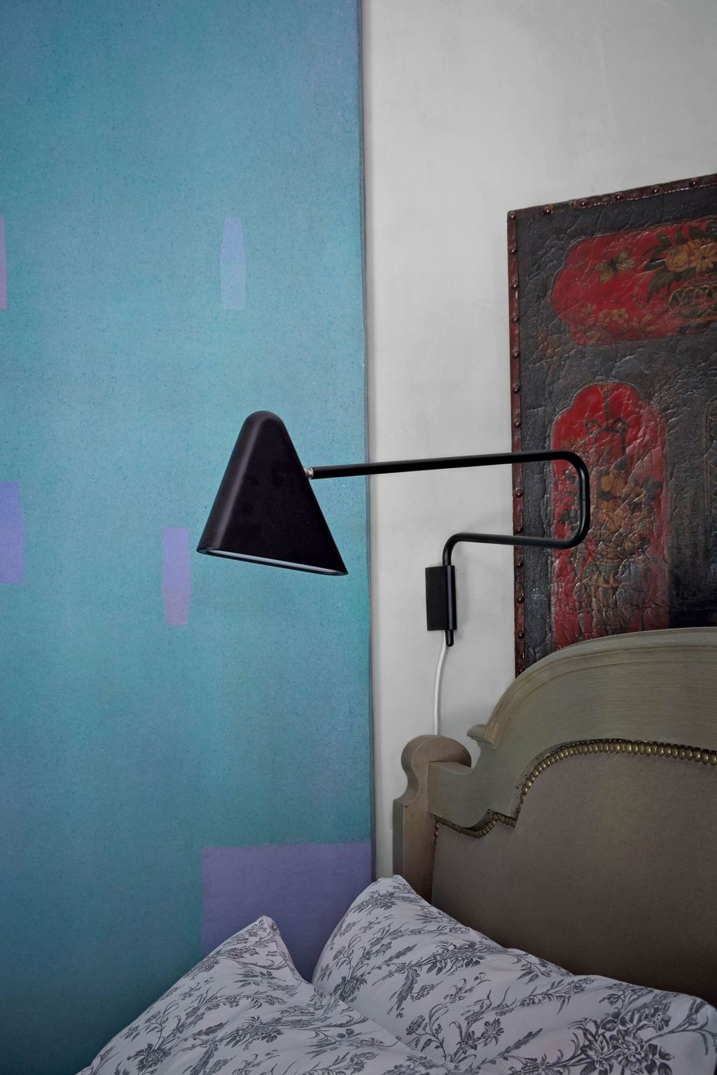 A Seventies abstract painting by W Nesseiz adds interest in the bedroom.