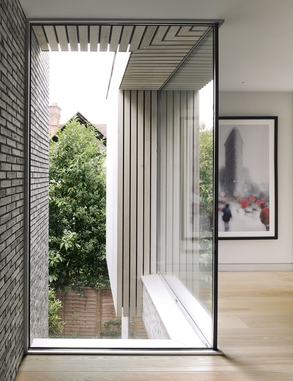 Ciaran Tullys Snow NYC photograph of the Flatiron Building hangs at the end of the corridor.