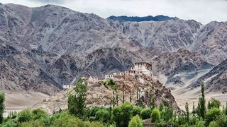 Image may contain Nature Outdoors Mountain Housing Architecture Building Monastery Scenery and Mountain Range