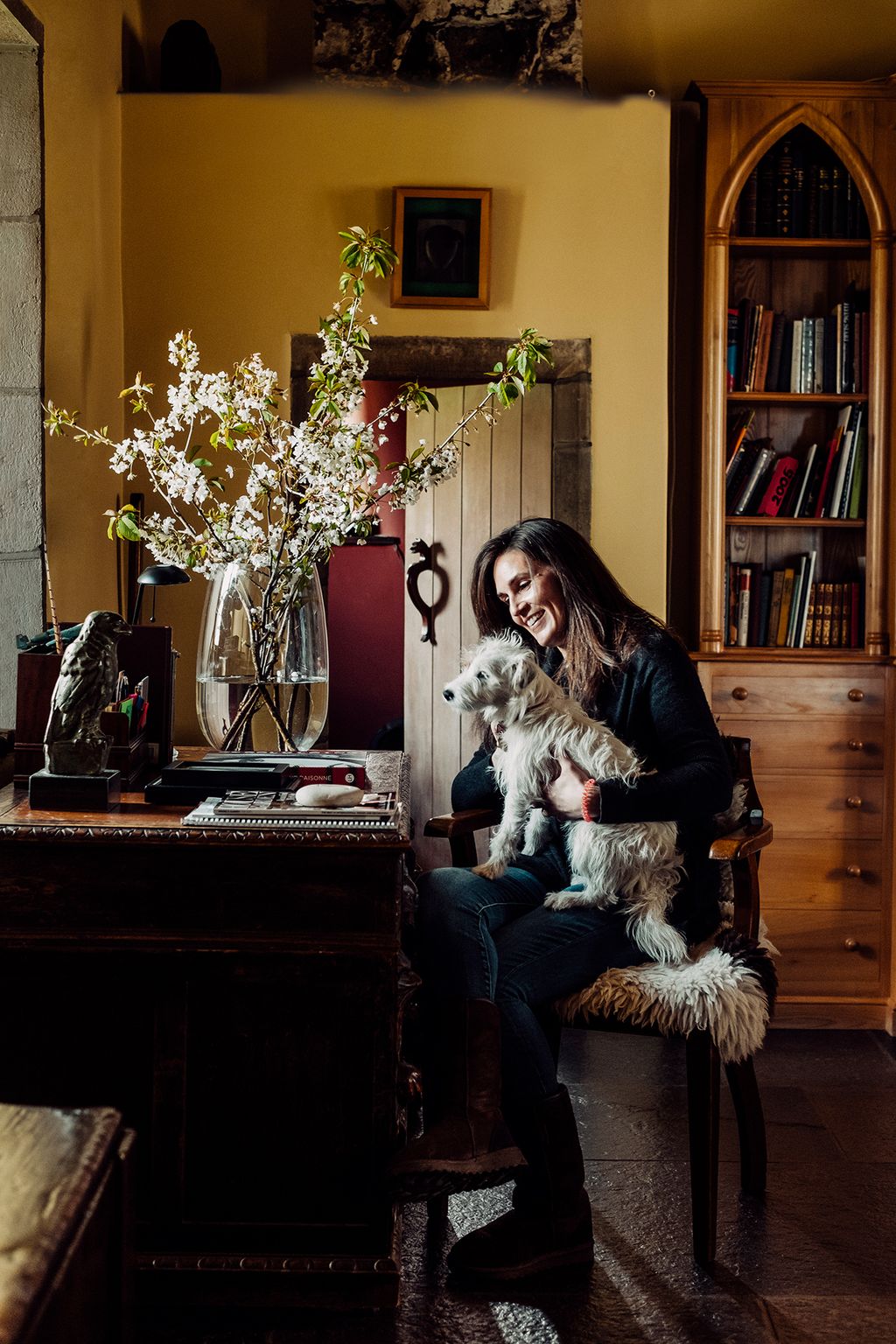 Image may contain Furniture Indoors Interior Design Shelf Plant Human Person Vase Pottery Jar Bookcase and Flower