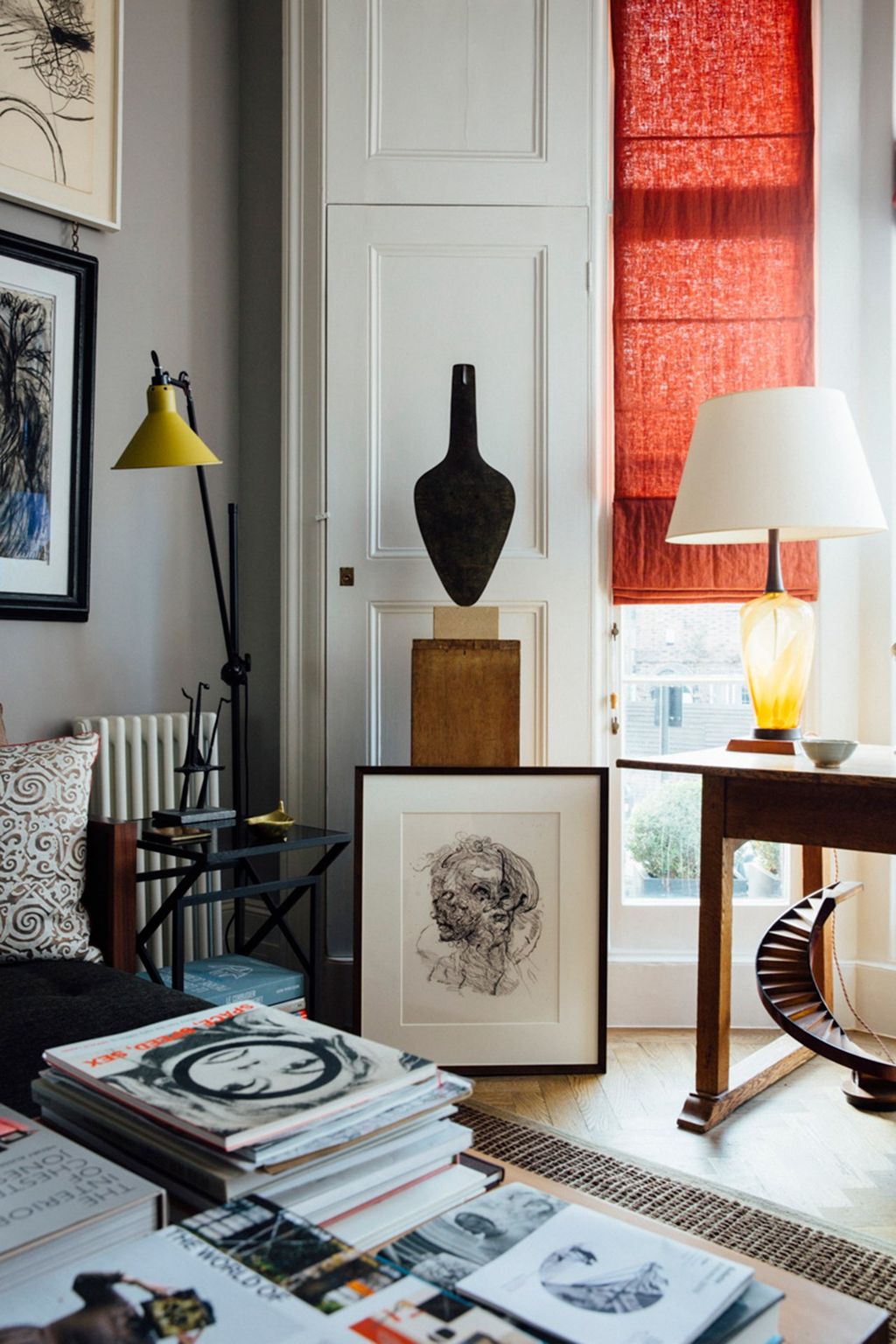 Image may contain Book Lamp Table Lamp Furniture Interior Design Indoors Living Room Room and Table