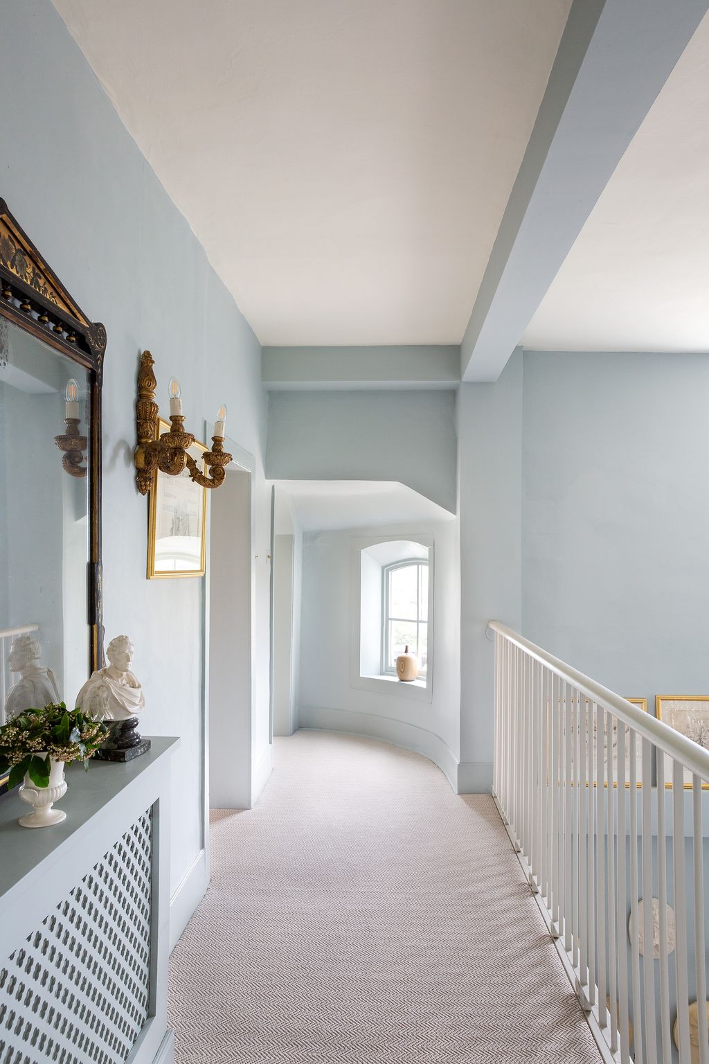 The upstairs landing leads from the main bedroom to another bedroom suite at the front of the house.