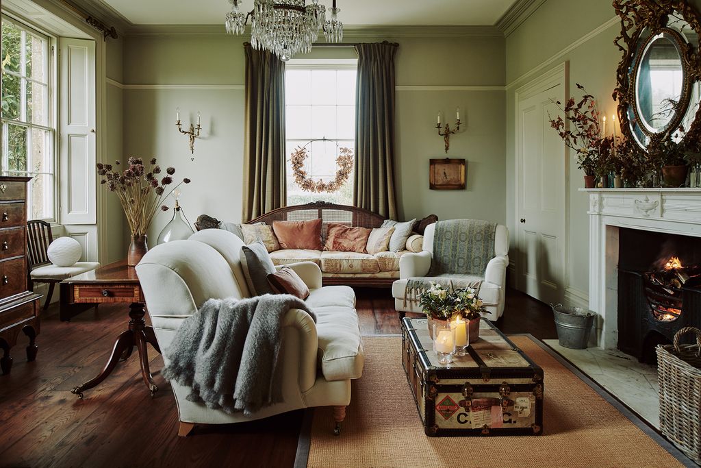 Image may contain Living Room Room Indoors Furniture Flooring Couch Wood Hardwood Interior Design Table and Floor