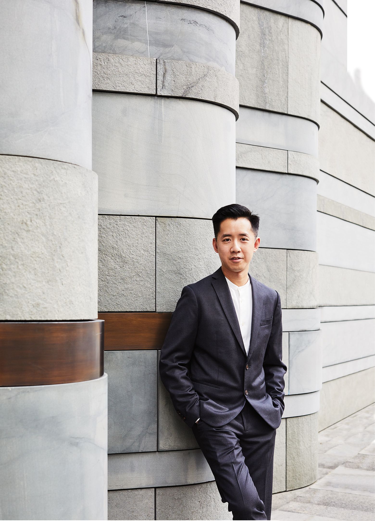 Image may contain Clothing Apparel Suit Coat Overcoat Jacket Blazer Human and Person