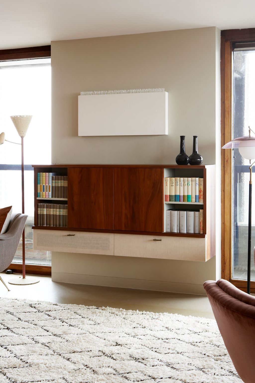 Image may contain Furniture Human Person Living Room Indoors Room Interior Design Wood Flooring Shelf and Rug