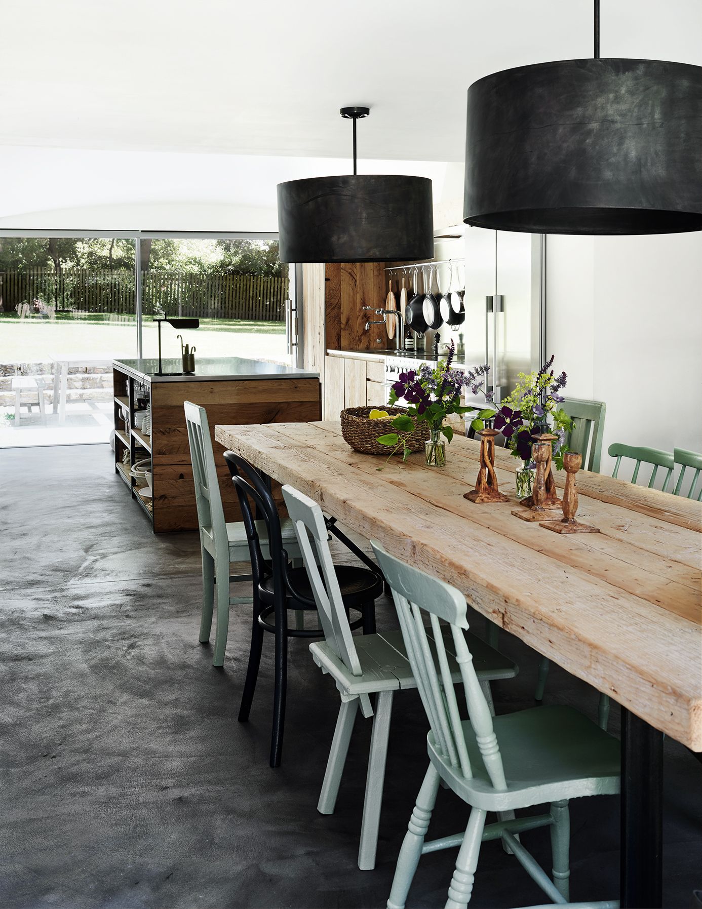 The raw oak kitchen is picked up in the salvaged wooden table that the owner brought back from Spain