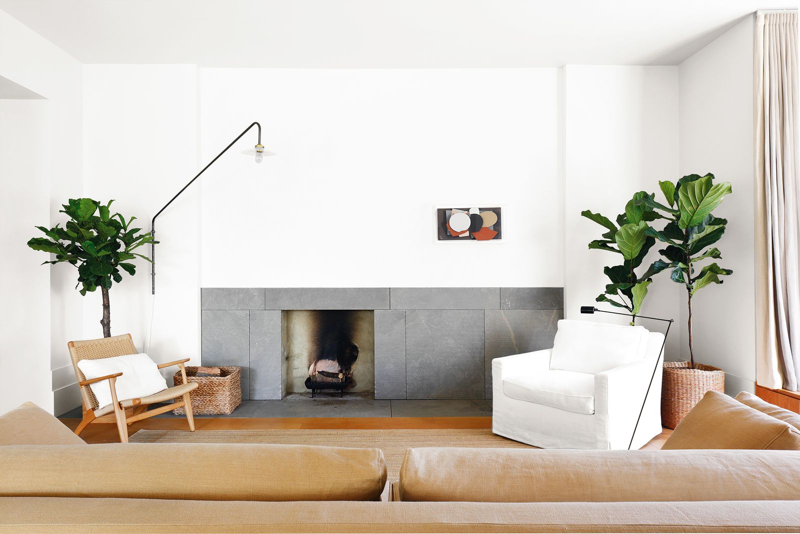 Image may contain Living Room Room Indoors Furniture Interior Design Fireplace Table Couch Hearth and Coffee Table