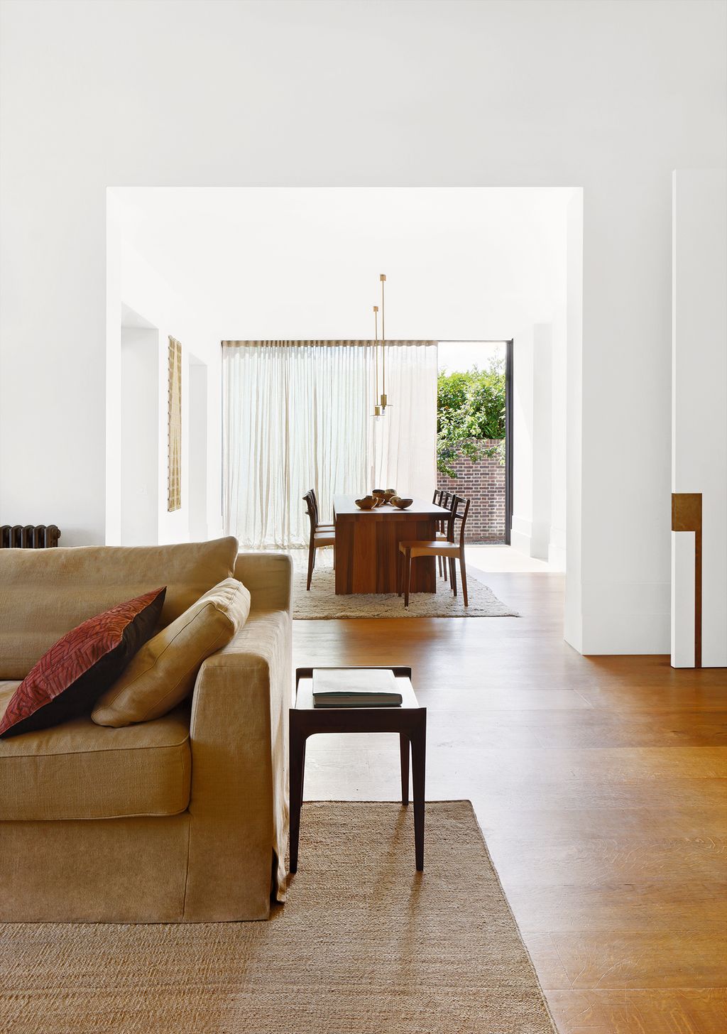 Image may contain Flooring Floor Living Room Room Indoors Furniture Couch Wood Hardwood and Rug