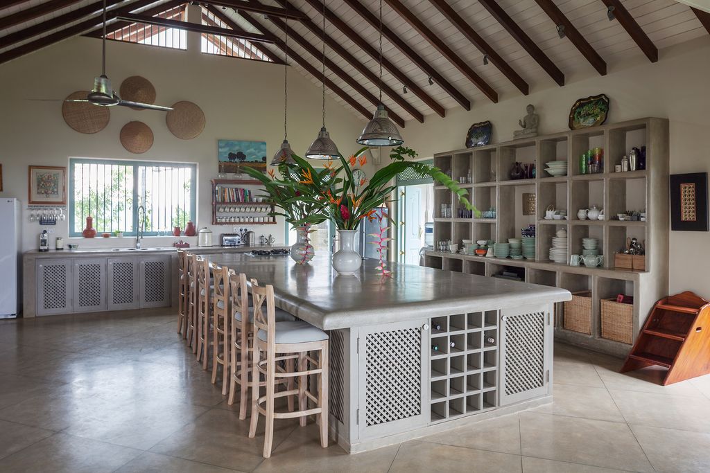 Image may contain Flooring Indoors Interior Design Wood Plant Room Kitchen Island Hardwood Flower Blossom and Vase