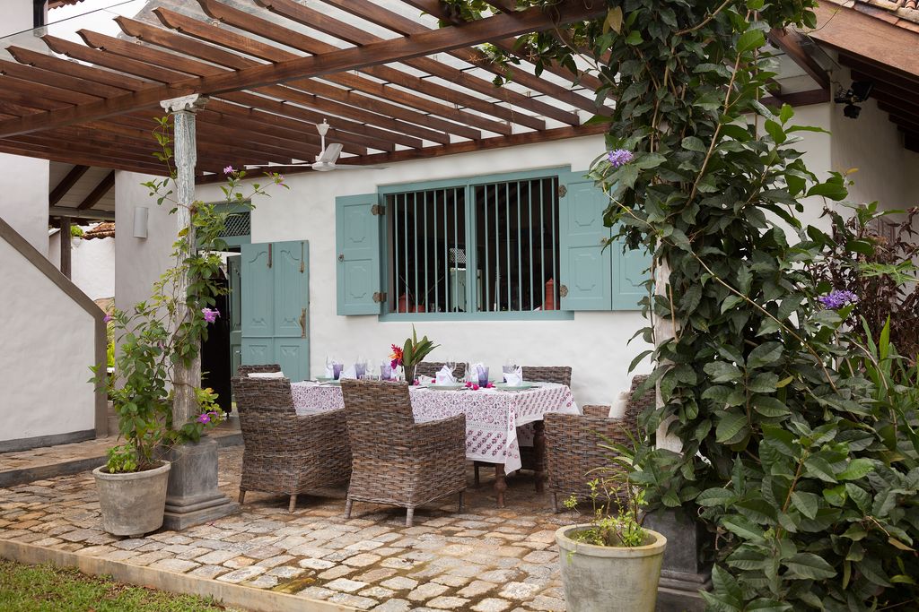 Image may contain Patio Porch Furniture Chair Pergola Flagstone Yard Outdoors Nature and Plant