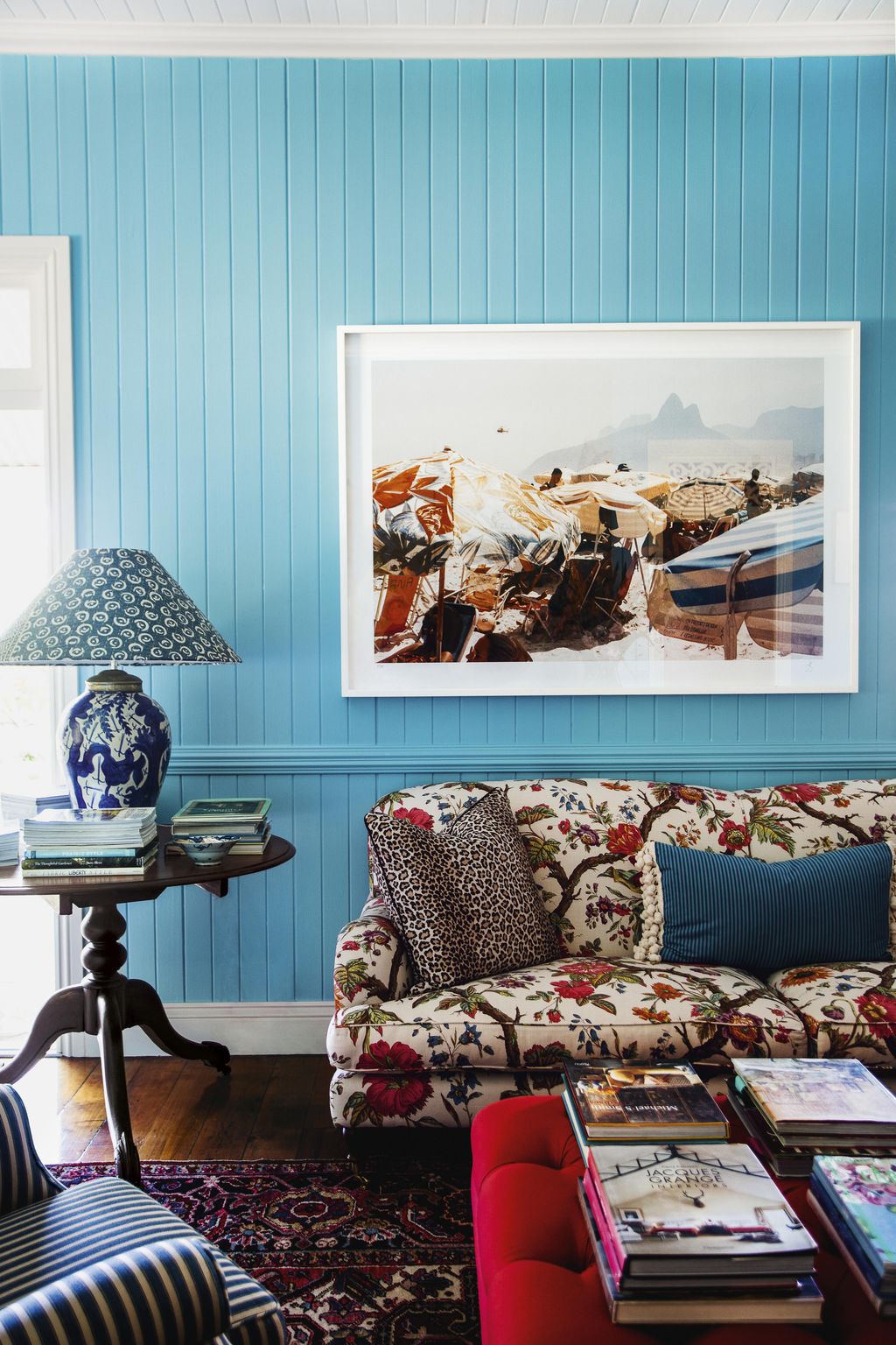 Image may contain Furniture Couch Living Room Room Indoors Lamp Table Lamp Book Cushion Home Decor and Vehicle