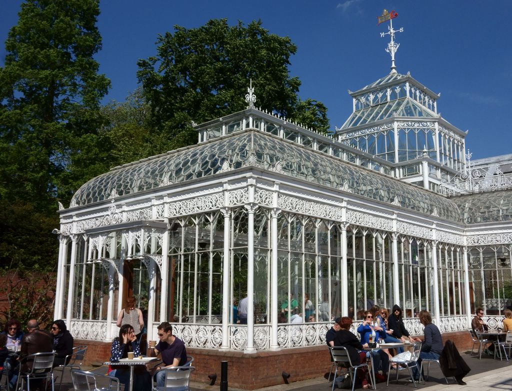 Image may contain Human Person City Town Urban Building Downtown Architecture Restaurant Furniture Chair and Cafe