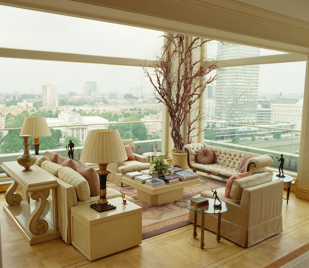 Image may contain Living Room Room Indoors Furniture Flooring Human Person Table Interior Design Wood and Couch