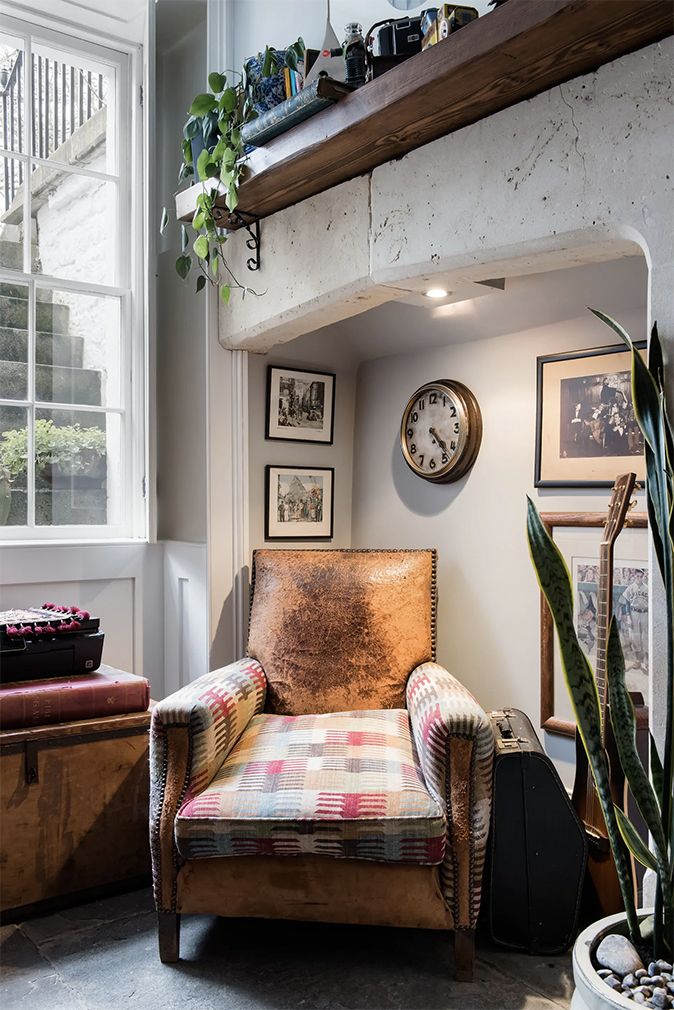 Image may contain Furniture Living Room Room Indoors Home Decor Clock Tower Architecture Tower Building and Couch