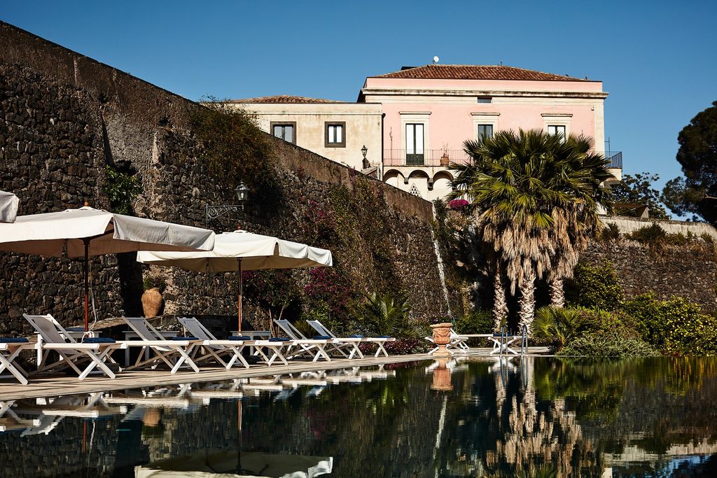 Image may contain Tree Plant Building Palm Tree Arecaceae Hotel and Outdoors