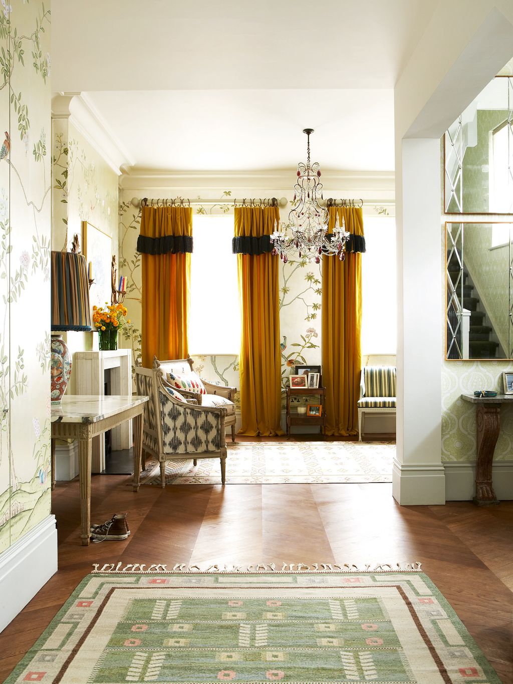 The mustardyellow curtain fabric in the drawing room is a cotton velvet by Osborne Little.