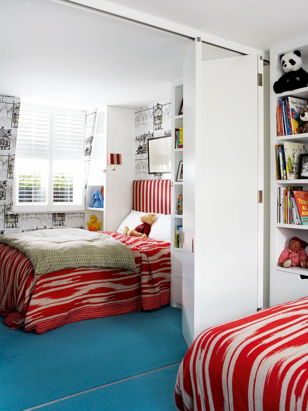 In the owner's sons' bedroom Stephan teamed a turquoise carpet with redand white bedlinen. The wallpaper also on the...